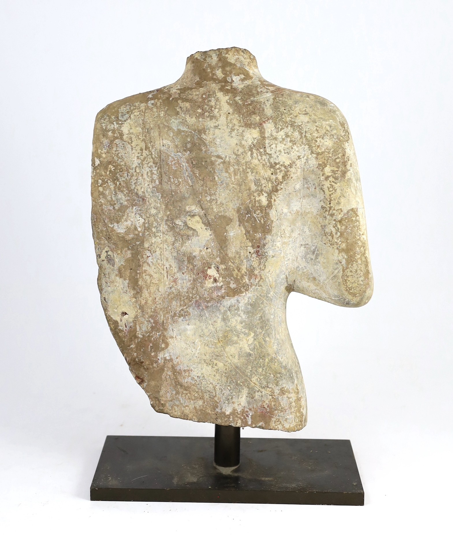 A Chinese pigment painted limestone torso of Buddha, probably Northern Qi dynasty (550-577 CE), 36cm high, mounted on a later base, total height 42.5cm